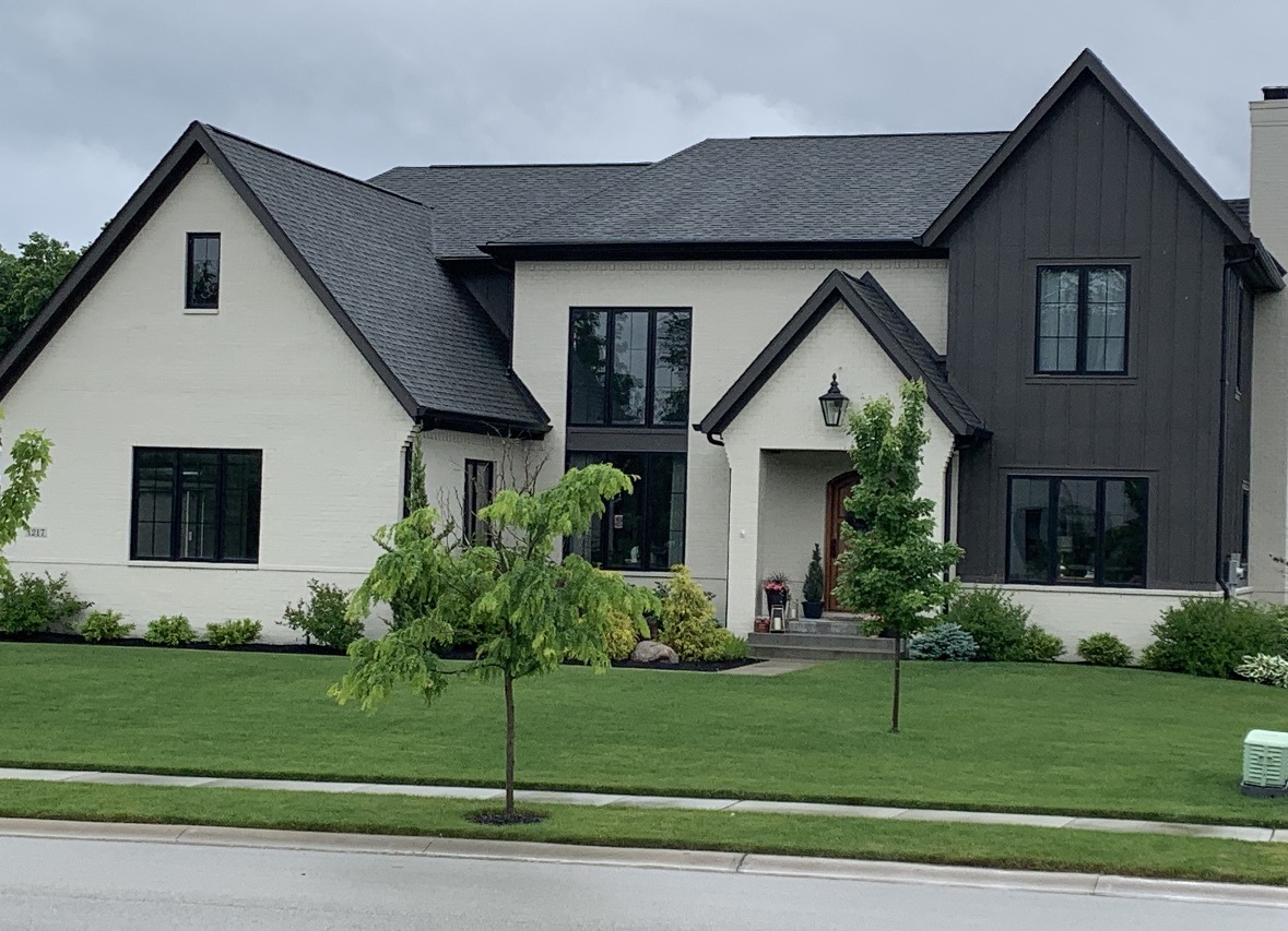 Modern farmhouse exterior in crisp white and black