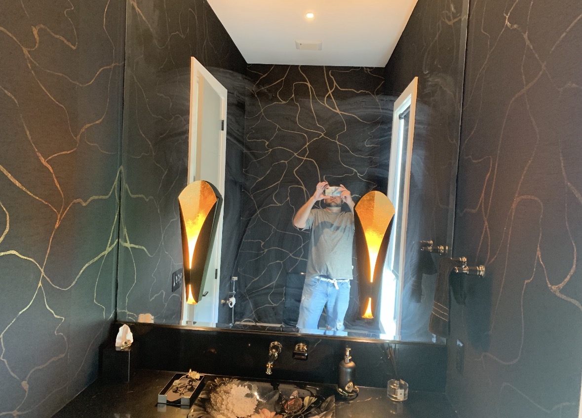 Dramatic dark powder room with marble walls